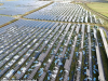 UK Solar Hits Record 15,420 Megawatts Output Solar panels on a rooftop in the UK under bright sunlight, generating electricity for the grid.