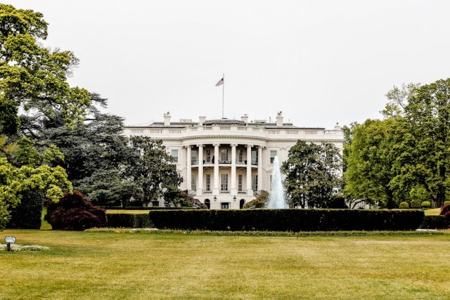 Trump Advisers Say He Plans to Test Constitutional Limits in Second Term Aerial view of a Texas border facility surrounded by fencing and patrol vehicles under a clear sky.