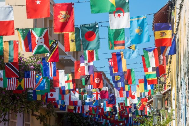 Pakistan Hosts First SCO Heads of Government Summit in Islamabad World leaders gather at a conference table during the SCO summit in Islamabad, with flags of member nations displayed behind them.