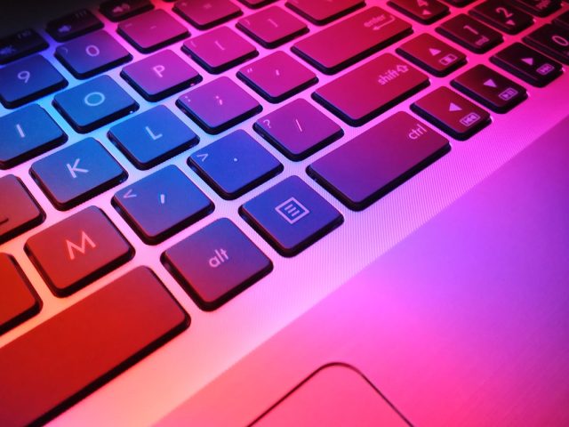 OpenAI's ChatGPT Redefines Professional Boundaries with Multimodal Capabilities A person typing on a laptop with a ChatGPT interface visible, surrounded by icons representing customer service, content creation, and coding tasks.