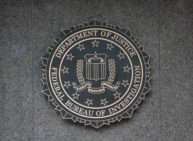 FBI Report Reveals U.S. Military Image of UAP Was Altered Before Review A grainy monochrome image with a crosshair reticle and a small dark circular object below center, representing a UAP sighting captured by a U.S. military system.