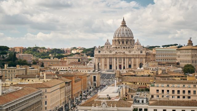 Cardinals Prepare for Conclave to Elect Successor After Pope Francis’ Death Cardinals in red robes walk through St. Peter's Square toward the Sistine Chapel for a papal conclave.