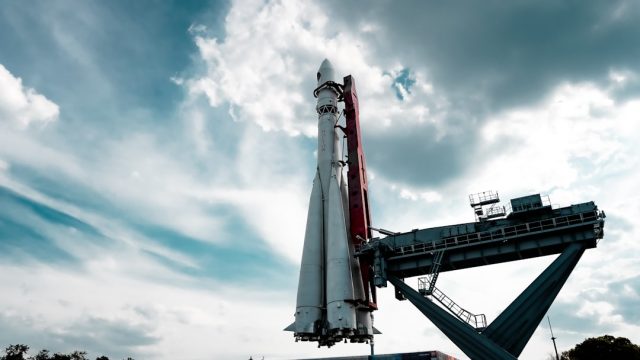 SpaceX Catches Super Heavy Booster with Launch Tower Arms During Flight Test 5 SpaceX Super Heavy booster held by steel Mechazilla arms at the launch tower after a successful catch during flight test 5.