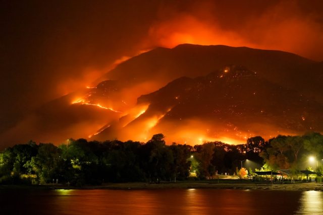 Study Finds Fire-Flood Double Punch Could Increase Eight-Fold in Pacific Northwest A hillside stripped bare by wildfire with dark mud and debris flowing down a slope after heavy rain.