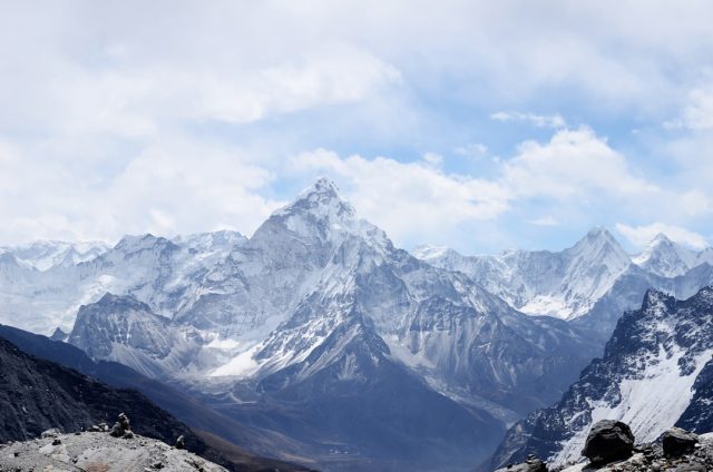 Police Suspend Search for Three Climbers Presumed Dead on Mount Cook Search and rescue team stands at the base of Mount Cook's steep ice and rock face.