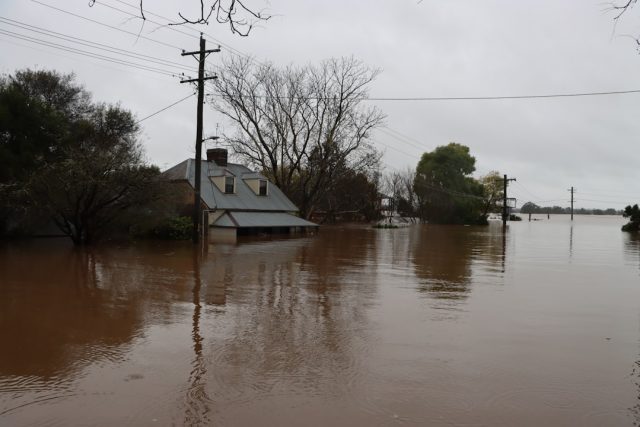 Kentucky Floods Leave 500 Roads Closed and Two People Dead Floodwaters cover a rural Kentucky road with submerged cars and debris near a hillside