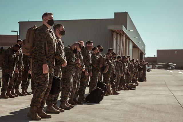 US expands access to Philippine bases under new defense deal US and Philippine flags fly together at a military camp construction site with barracks and warehouses under development.