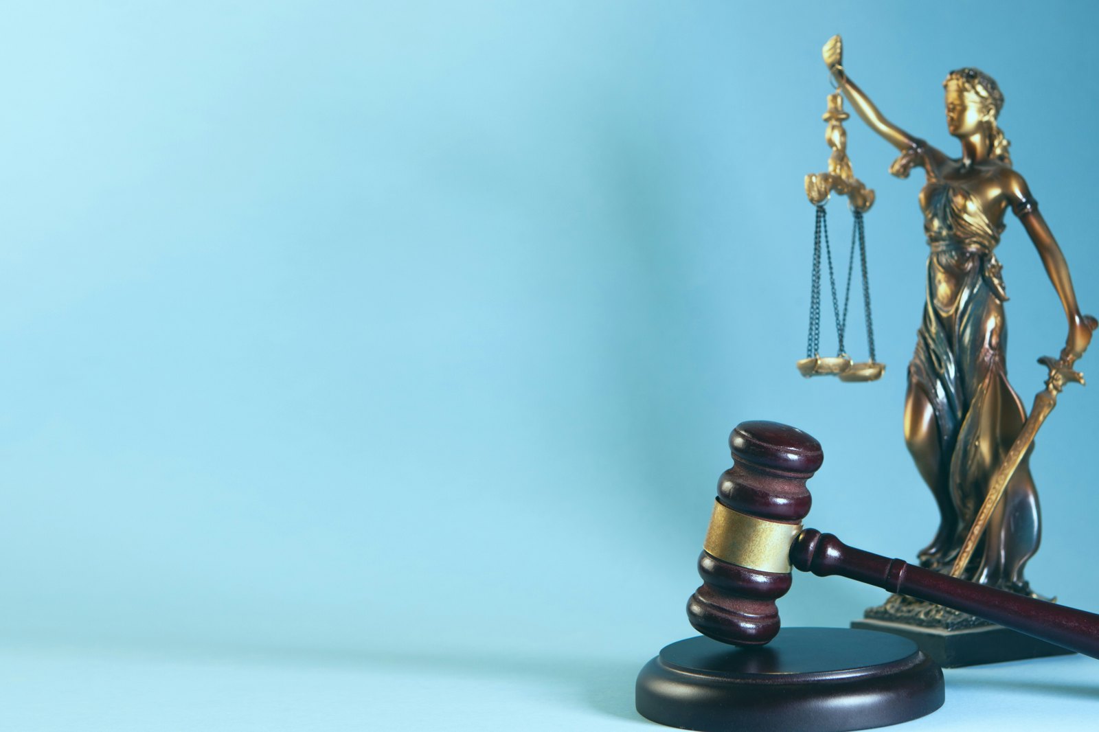 Lady justice and gavel on a blue background